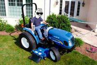 boomer drives big new holland mower tractor 