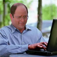 george costanza smirking on computer 