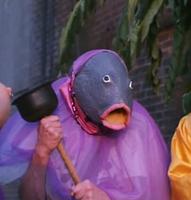 guy in fish costume holding plunger 